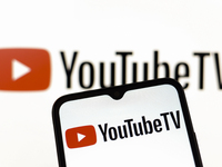 The YouTube TV logo appears on the screen of a smartphone and in the background on the computer screen in Reno, United States, on December 1...