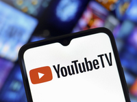 The YouTube TV logo appears on the screen of a smartphone and in the background on the computer screen in Reno, United States, on December 1...