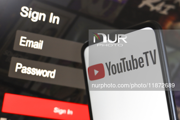 The YouTube TV logo appears on a smartphone screen next to a login screen with email and password in Reno, United States, on December 15, 20...