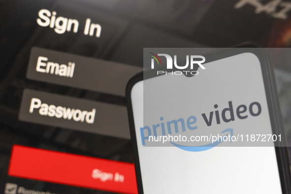 The Amazon Prime Video logo appears on a smartphone screen next to a login screen with email and password in Reno, United States, on Decembe...