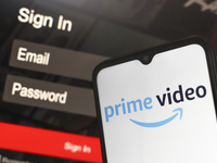 The Amazon Prime Video logo appears on a smartphone screen next to a login screen with email and password in Reno, United States, on Decembe...