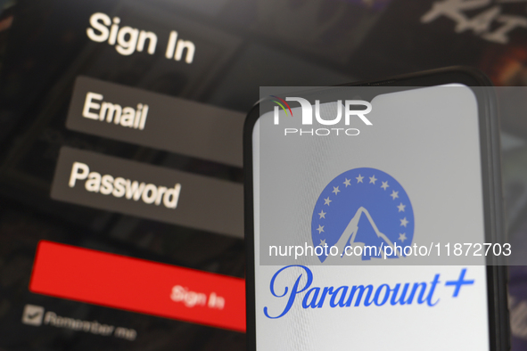 The Paramount Plus logo appears on a smartphone screen next to a login screen with email and password in Reno, United States, on December 15...