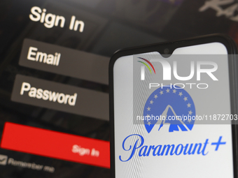 The Paramount Plus logo appears on a smartphone screen next to a login screen with email and password in Reno, United States, on December 15...