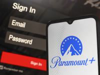 The Paramount Plus logo appears on a smartphone screen next to a login screen with email and password in Reno, United States, on December 15...