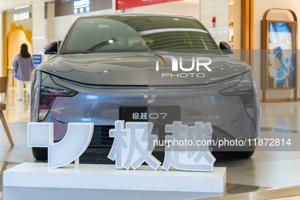 Pedestrians pass an empty Jidu auto shop in Chongqing, China, on December 14, 2024. 