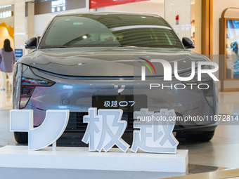 Pedestrians pass an empty Jidu auto shop in Chongqing, China, on December 14, 2024. (