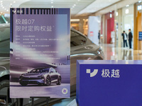 Pedestrians pass an empty Jidu auto shop in Chongqing, China, on December 14, 2024. (