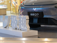 Pedestrians pass an empty Jidu auto shop in Chongqing, China, on December 14, 2024. (