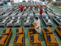 A worker produces sofas for sale to Europe and the United States in a furniture workshop in Suqian, Jiangsu province, China, on December 15,...