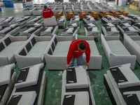 A worker produces sofas for sale to Europe and the United States in a furniture workshop in Suqian, Jiangsu province, China, on December 15,...