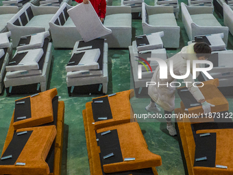 A worker produces sofas for sale to Europe and the United States in a furniture workshop in Suqian, Jiangsu province, China, on December 15,...