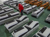 A worker produces sofas for sale to Europe and the United States in a furniture workshop in Suqian, Jiangsu province, China, on December 15,...