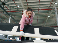 A worker produces sofas for sale to Europe and the United States in a furniture workshop in Suqian, Jiangsu province, China, on December 15,...