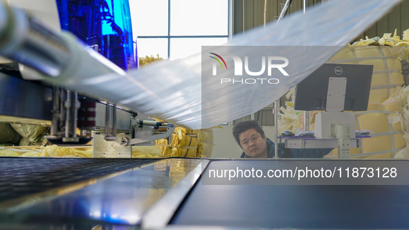 A worker produces sofas for sale to Europe and the United States in a furniture workshop in Suqian, Jiangsu province, China, on December 15,...