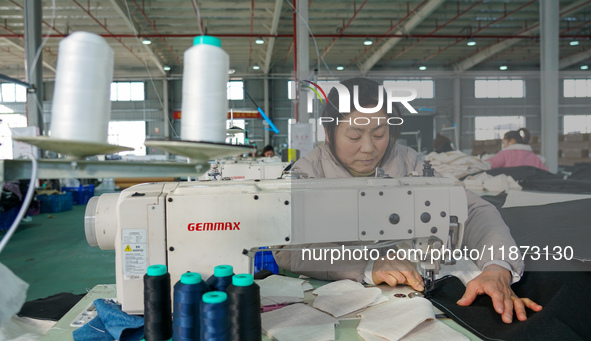 A worker produces sofas for sale to Europe and the United States in a furniture workshop in Suqian, Jiangsu province, China, on December 15,...