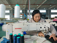 A worker produces sofas for sale to Europe and the United States in a furniture workshop in Suqian, Jiangsu province, China, on December 15,...