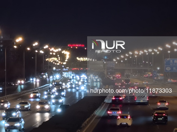 Vehicles travel along the West Fourth Ring Road at night in Beijing, China, on December 15, 2024. 