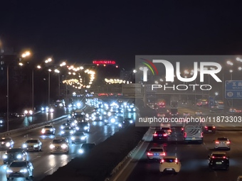 Vehicles travel along the West Fourth Ring Road at night in Beijing, China, on December 15, 2024. (