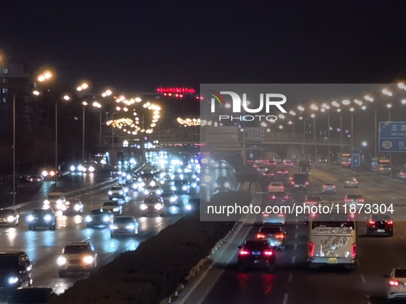 Vehicles travel along the West Fourth Ring Road at night in Beijing, China, on December 15, 2024. 