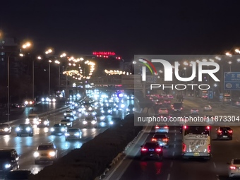 Vehicles travel along the West Fourth Ring Road at night in Beijing, China, on December 15, 2024. (