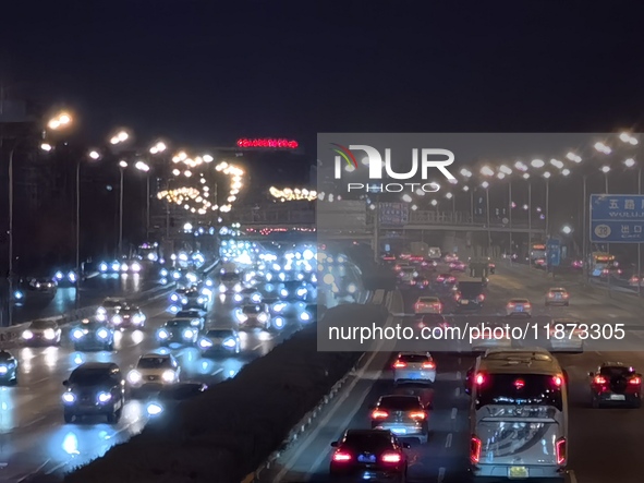 Vehicles travel along the West Fourth Ring Road at night in Beijing, China, on December 15, 2024. 