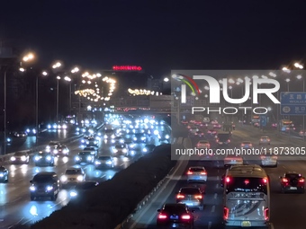 Vehicles travel along the West Fourth Ring Road at night in Beijing, China, on December 15, 2024. (