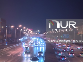 Vehicles travel along the West Fourth Ring Road at night in Beijing, China, on December 15, 2024. (