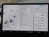 The images show the Tesla Model Y equipped with its Level 2 autonomous driving capabilities. The photos highlight the vehicle's logo, the na...