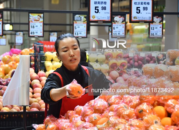 A consumer shops at a supermarket in Handan, China, on December 9, 2024. On December 16, 2024, the National Bureau of Statistics releases da...