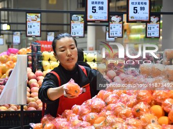 A consumer shops at a supermarket in Handan, China, on December 9, 2024. On December 16, 2024, the National Bureau of Statistics releases da...