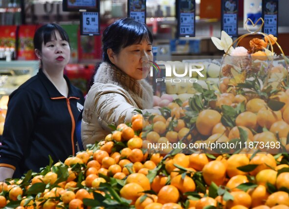 A consumer shops at a supermarket in Handan, China, on December 9, 2024. On December 16, 2024, the National Bureau of Statistics releases da...