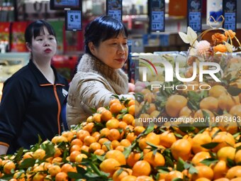 A consumer shops at a supermarket in Handan, China, on December 9, 2024. On December 16, 2024, the National Bureau of Statistics releases da...