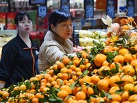 A consumer shops at a supermarket in Handan, China, on December 9, 2024. On December 16, 2024, the National Bureau of Statistics releases da...