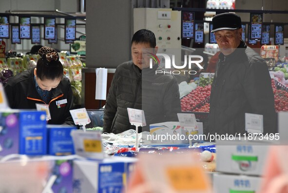 A consumer shops at a supermarket in Handan, China, on December 9, 2024. On December 16, 2024, the National Bureau of Statistics releases da...