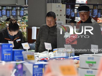 A consumer shops at a supermarket in Handan, China, on December 9, 2024. On December 16, 2024, the National Bureau of Statistics releases da...