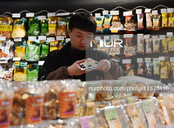 A consumer shops at a supermarket in Handan, China, on December 9, 2024. On December 16, 2024, the National Bureau of Statistics releases da...