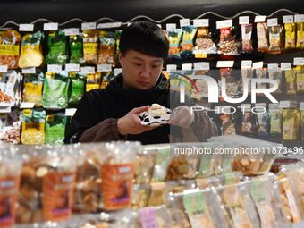 A consumer shops at a supermarket in Handan, China, on December 9, 2024. On December 16, 2024, the National Bureau of Statistics releases da...