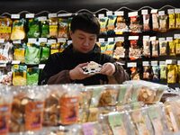 A consumer shops at a supermarket in Handan, China, on December 9, 2024. On December 16, 2024, the National Bureau of Statistics releases da...