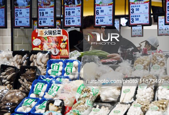 A consumer shops at a supermarket in Handan, China, on December 9, 2024. On December 16, 2024, the National Bureau of Statistics releases da...