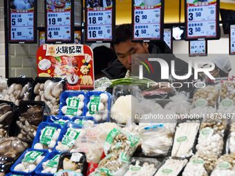 A consumer shops at a supermarket in Handan, China, on December 9, 2024. On December 16, 2024, the National Bureau of Statistics releases da...