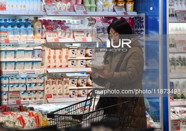 A consumer shops at a supermarket in Handan, China, on December 9, 2024. On December 16, 2024, the National Bureau of Statistics releases da...