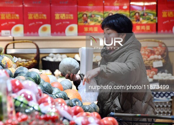 A consumer shops at a supermarket in Handan, China, on December 9, 2024. On December 16, 2024, the National Bureau of Statistics releases da...