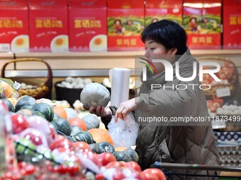 A consumer shops at a supermarket in Handan, China, on December 9, 2024. On December 16, 2024, the National Bureau of Statistics releases da...