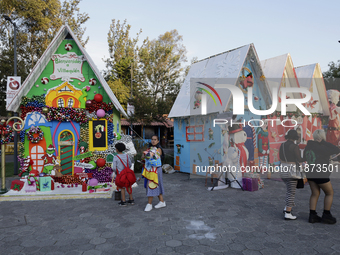 Dozens of people visit a Christmas village set up in the Tlahuac Forest in Mexico City, Mexico, on December 15, 2024. (