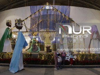 Dozens of people visit a Christmas village set up in the Tlahuac Forest in Mexico City, Mexico, on December 15, 2024. (