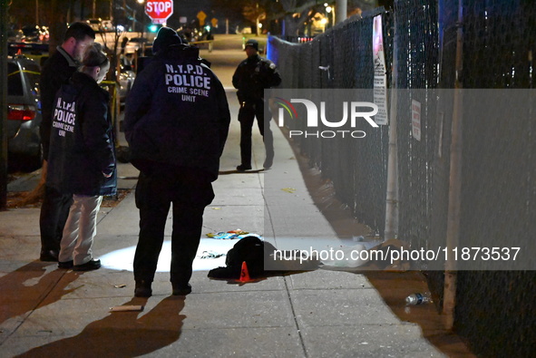 New York City Police Department crime scene investigators stage at the scene where a 26-year-old man identified as Tyreek Moore is shot and...