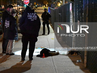 New York City Police Department crime scene investigators stage at the scene where a 26-year-old man identified as Tyreek Moore is shot and...