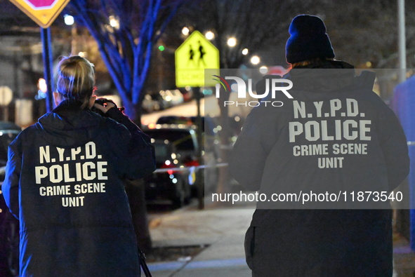 New York City Police Department crime scene investigators stage at the scene where a 26-year-old man identified as Tyreek Moore is shot and...