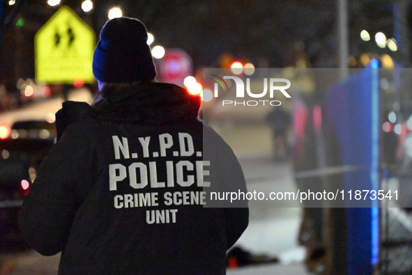 New York City Police Department crime scene investigators stage at the scene where a 26-year-old man identified as Tyreek Moore is shot and...