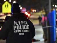 New York City Police Department crime scene investigators stage at the scene where a 26-year-old man identified as Tyreek Moore is shot and...